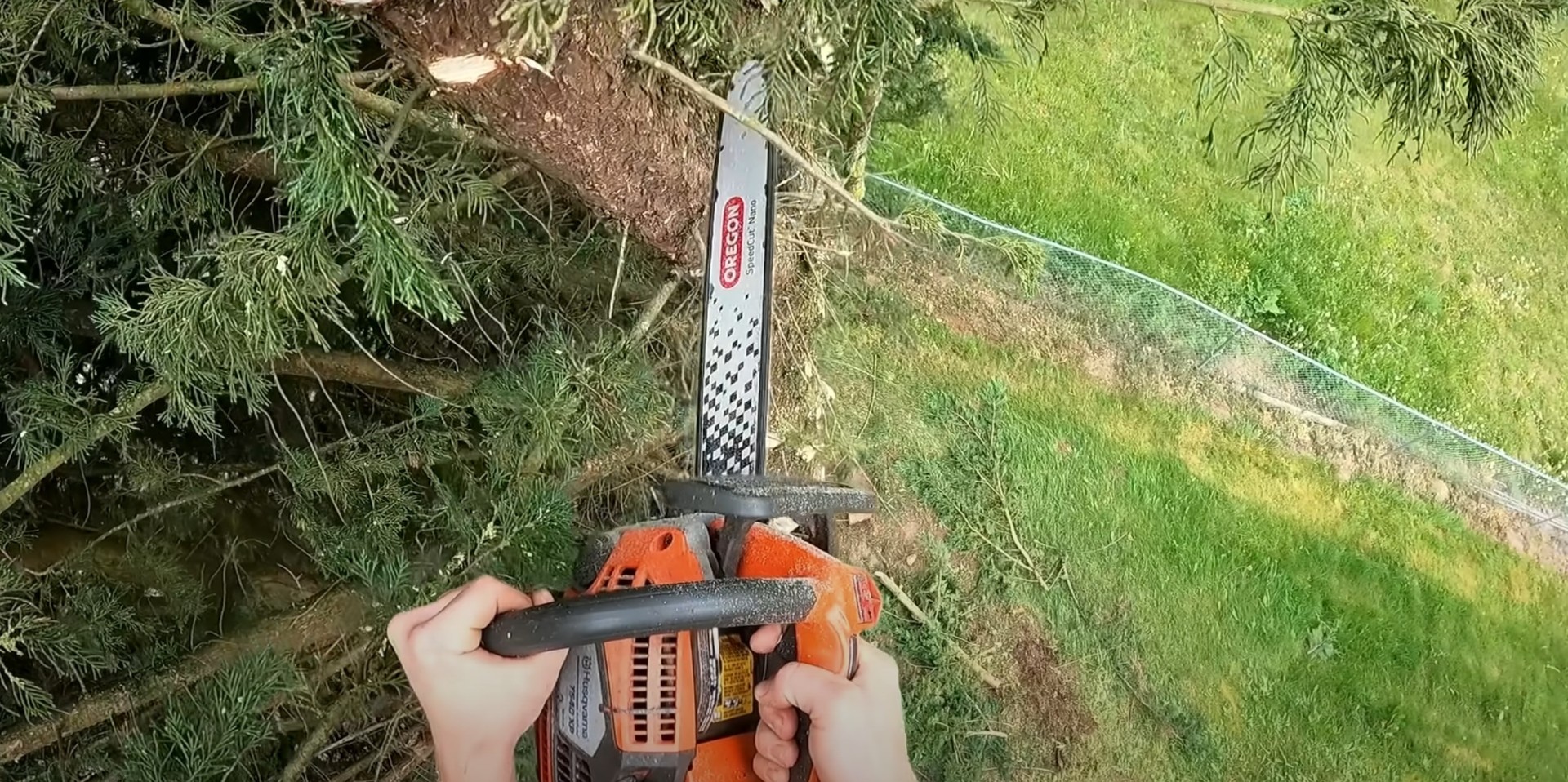 Professional chainsaw operation for safe and efficient tree cutting services Chainsaw being used for precise tree cutting and branch removal in residential setting
