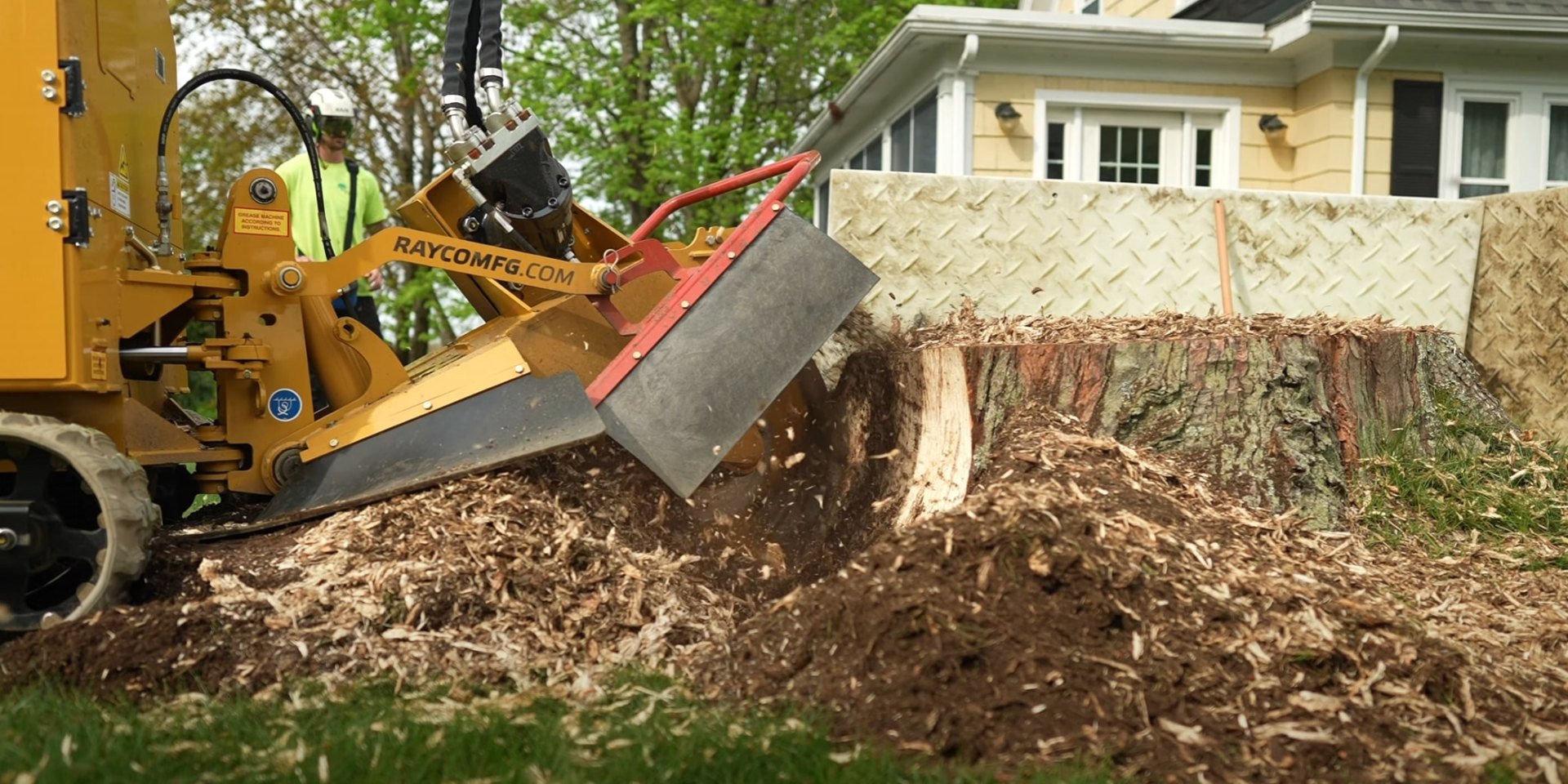 Professional stump grinding and removal services for clean landscape restoration Stump grinding machine removing tree stump from residential yard, creating wood chips